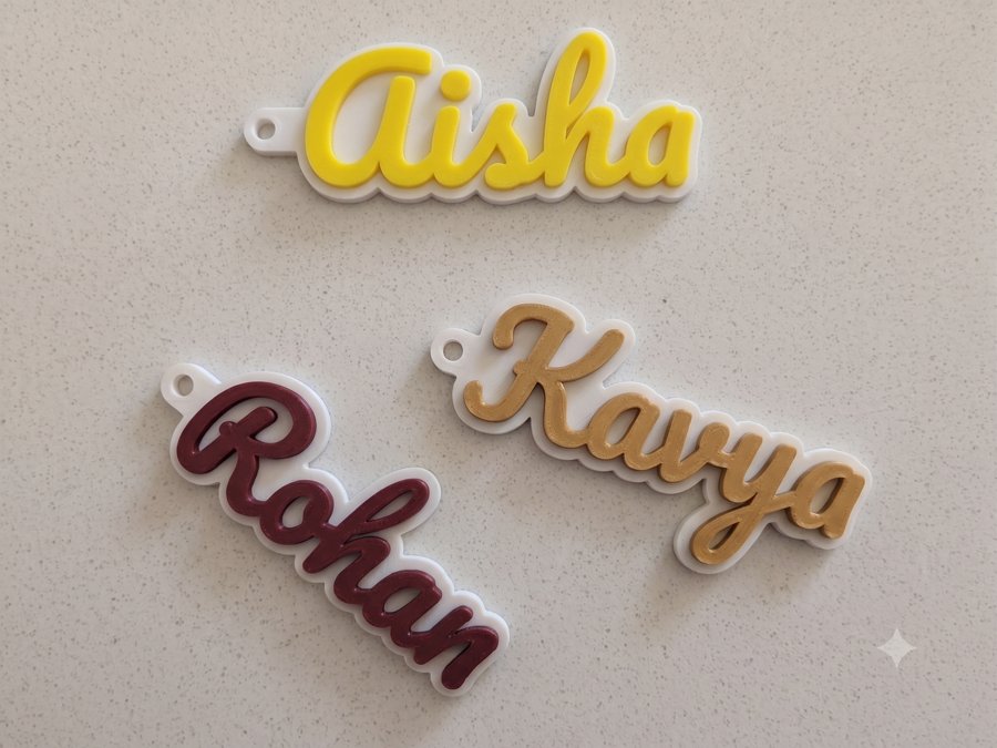 A personalised Bombay 3D Studio keychain, name engraved on the tag